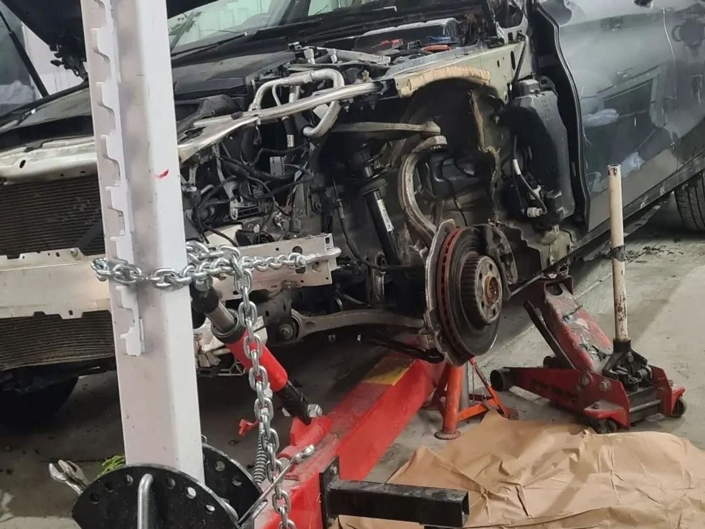 A car stripped to its front chassis and set up on an alignment jig at N17 Bodyworks