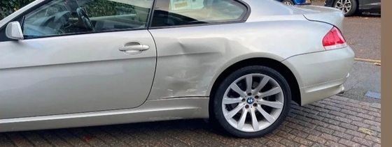 Silver BMW 6 Series with impact damage down the door and rear quarter