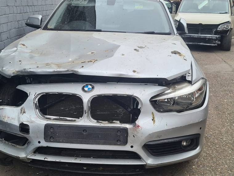 Silver BMW 1 Series with heavy front-end collision damage