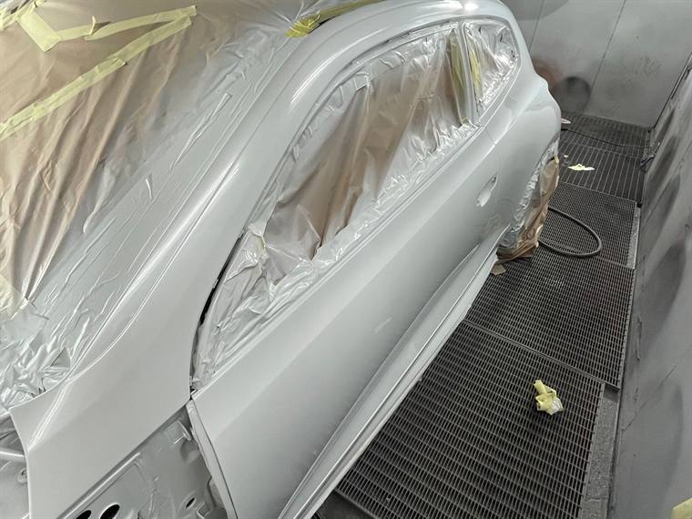 A car side panel prepped and masked ready for colour