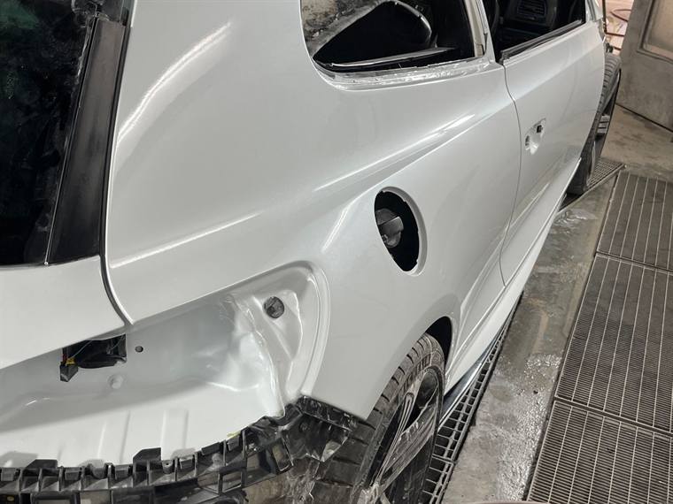 White hatchback rear quarter panel repaired and painted