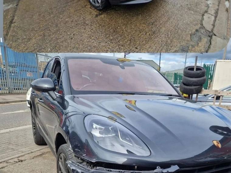 Dark blue Porsche Macan with front-end accident damage