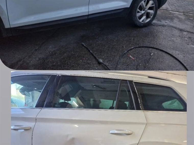 White estate car with side impact damage across two doors